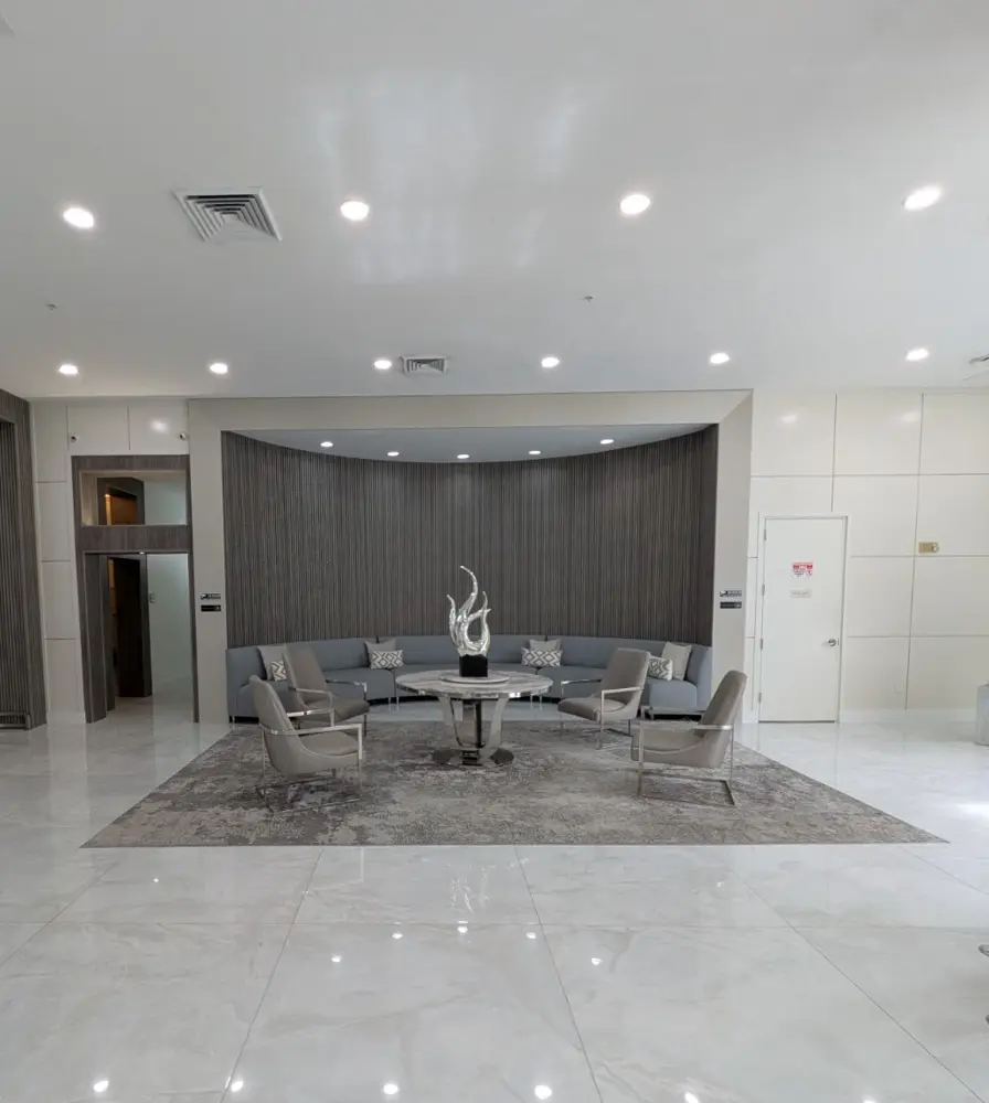 East tower lobby lounge with curved sofa and slatted wood wall