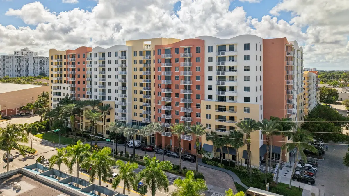 Aerial view of The Venture at Aventura, Aventura, FL, the coral, yellow and white towers along the palm-lined street