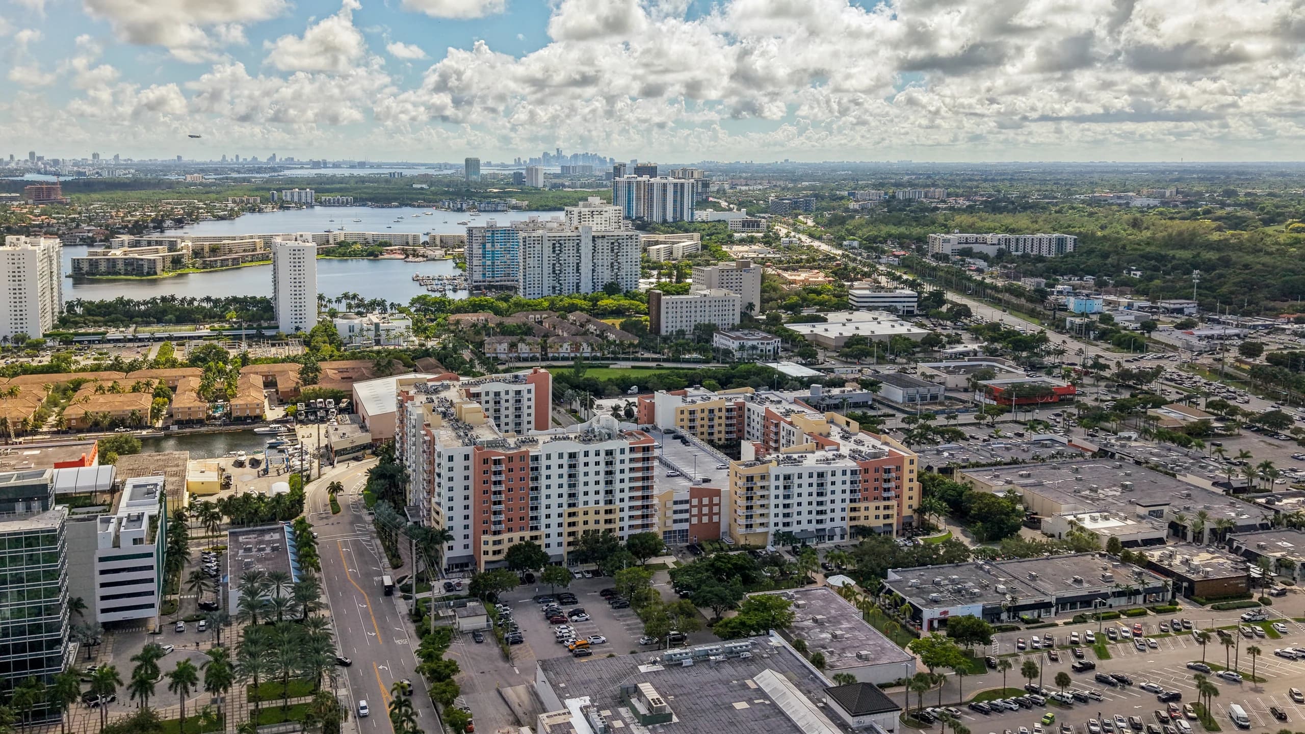 Aerial view of The Venture at Aventura, Aventura, FL, with the lake and neighboring towers behind