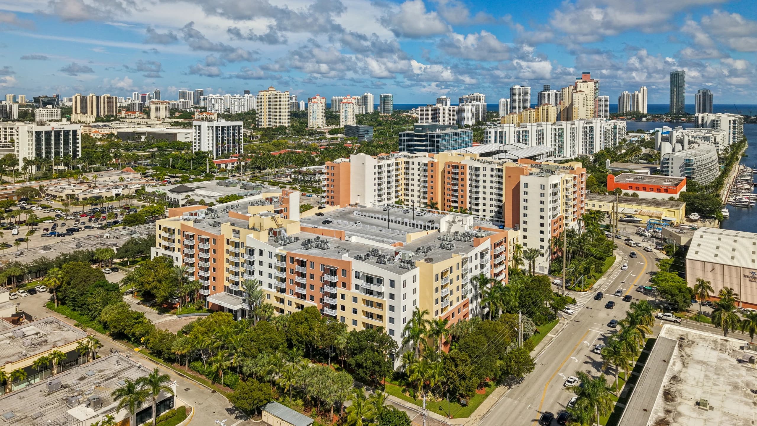 Aerial view of The Venture at Aventura, Aventura, FL, with the city and water in the distance